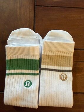 Lululemon unisex White Crew Socks with Green Stripes and one with Tan Stripes